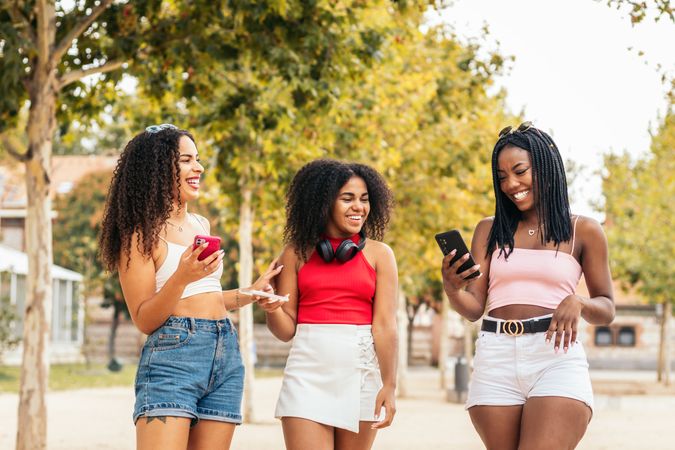 Black Friends Enjoying Summer Together and using smartphone