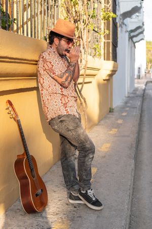 Street musician playing harmonica standing on the street