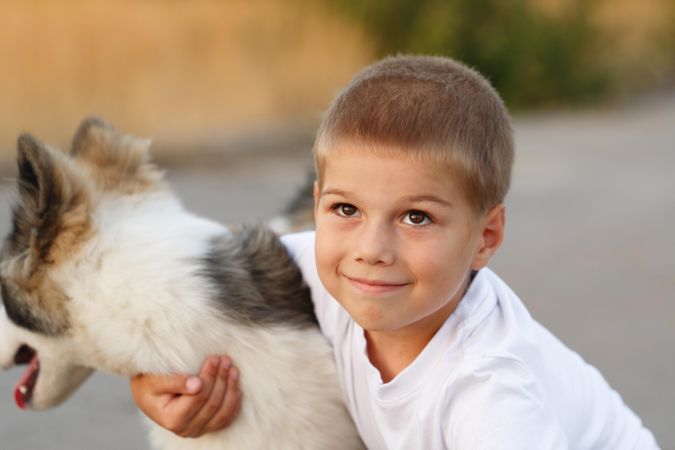 Cute young male with husky dog