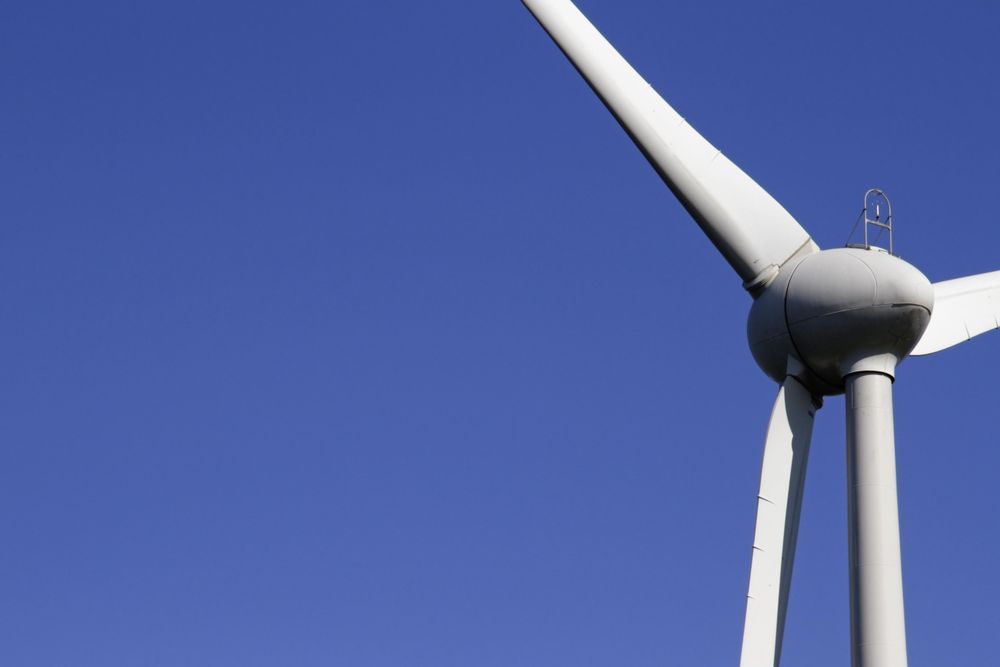 Wind turbine under blue sky