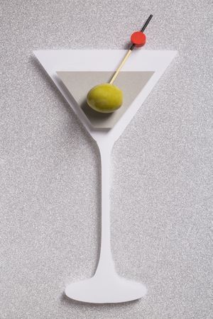 Silhouette of a martini cocktail made with cardboard with real olive