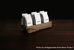 Wooden block displaying bags of coffee beans 0gye84