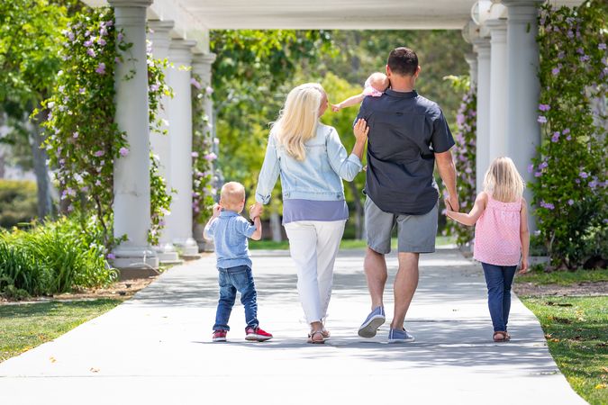 Young Family Taking A Walk In The Park