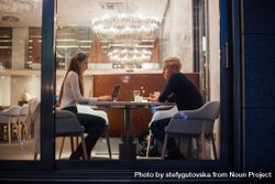 Man and woman having a casual study session in a restaurant 4BL8M0