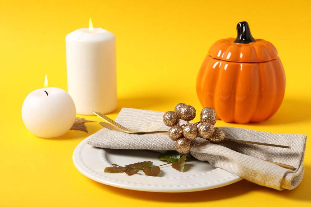 Concept of Thanksgiving day, Autumn table setting on yellow background