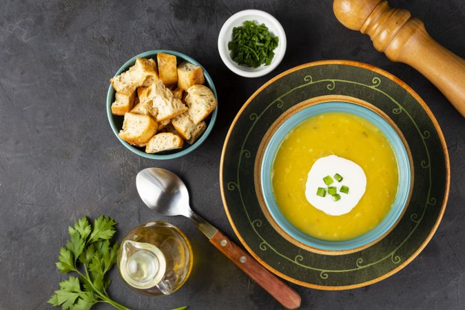 Bowl with pumpkin soup on the table.