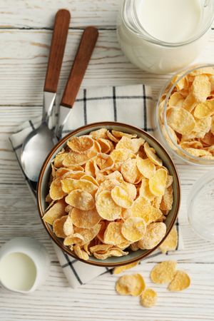 Concept of breakfast with muesli and milk on wooden table