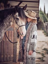 Woman near horse in stable