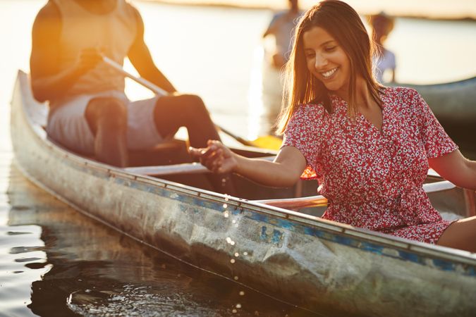 Woman splashing water from a canoe