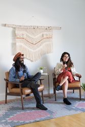 Two colleagues giving a talk with the woman addressing the room