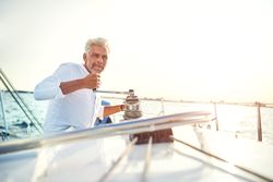 Man on sailing yacht on bright day