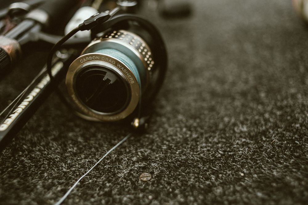 Fishing reel with fishing line on ground