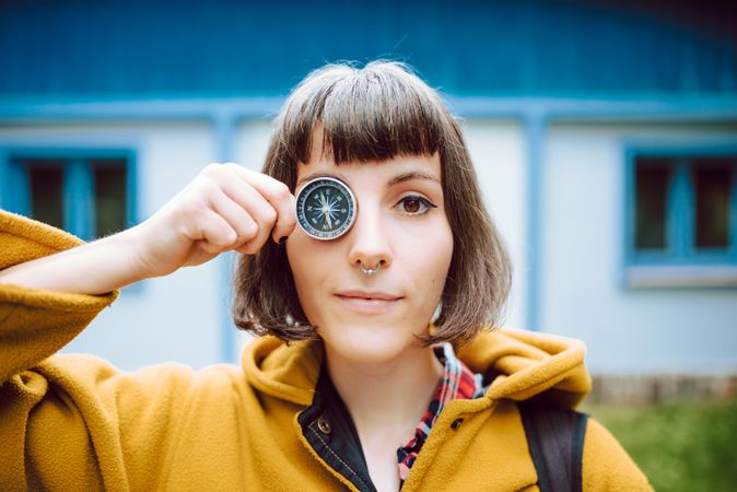Funny woman with compass near eye