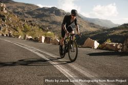 Fit athlete cycling road bike on a mountain road 5zA8j0