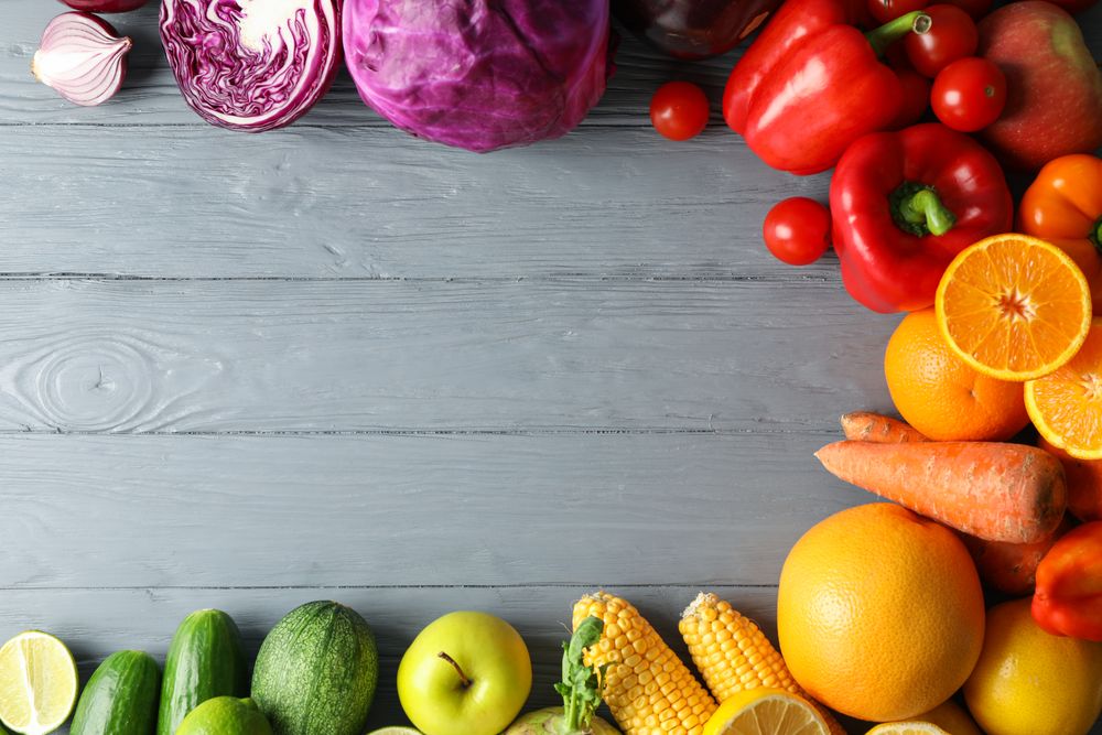 Different vegetables and fruits on wooden background, copy space