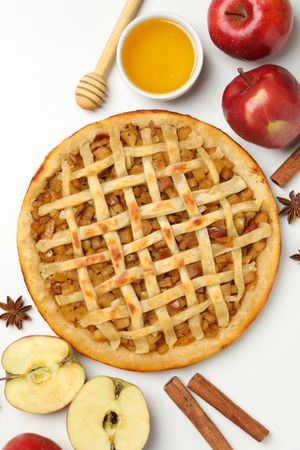 Composition with tasty apple pie on background, top view