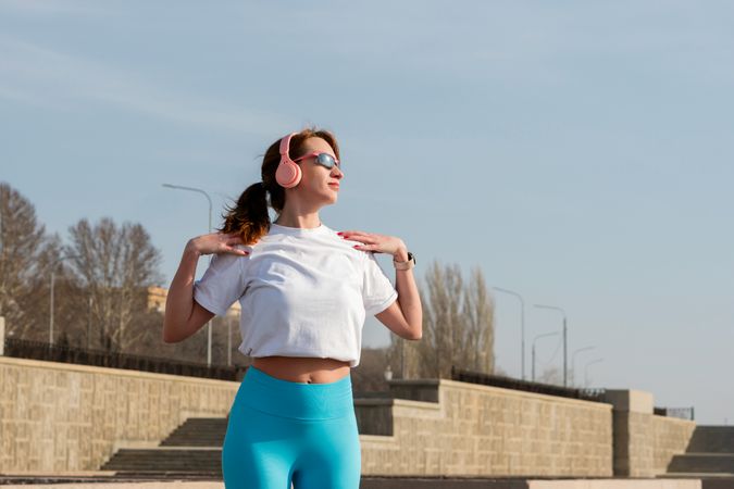 Woman doing warm up before workout on street