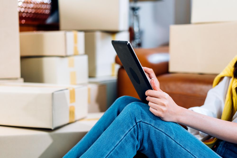 Hand of small business owner working on digital tablet checking order