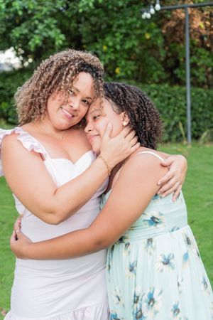 Latina mother with teenage daughter in park