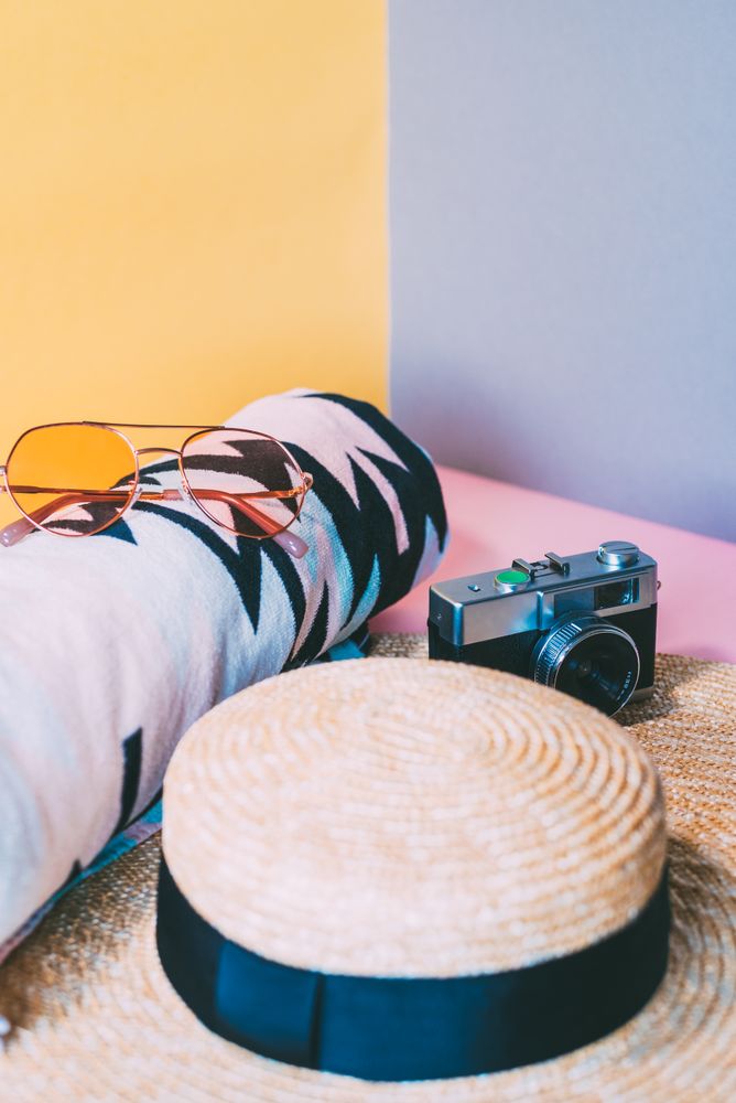 Summer trendy sunglasses, towel, hat and camera