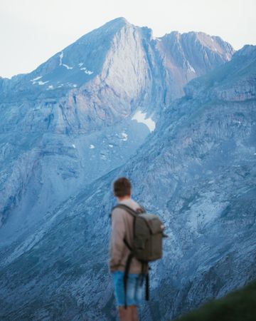 Unrecognizable man with backpack hiking in Pyrenees mountains