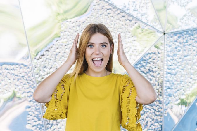 Young shy woman covering ears
