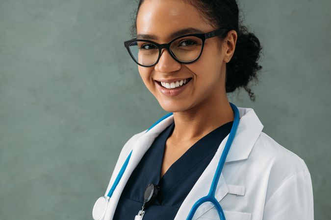 Portrait of smiling female Black doctor in lab coat and stethoscope