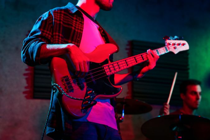 Bass Player In Stage With Colorful Lights