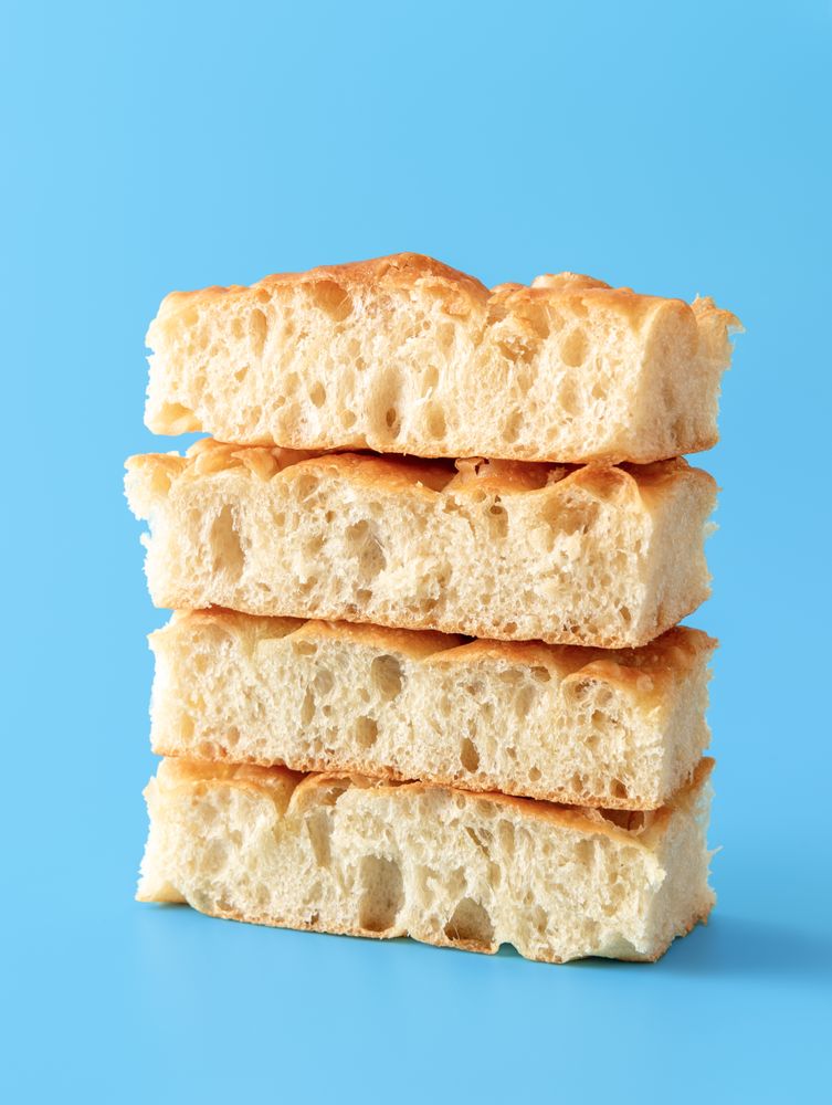 Focaccia bread slices minimalist on a blue background