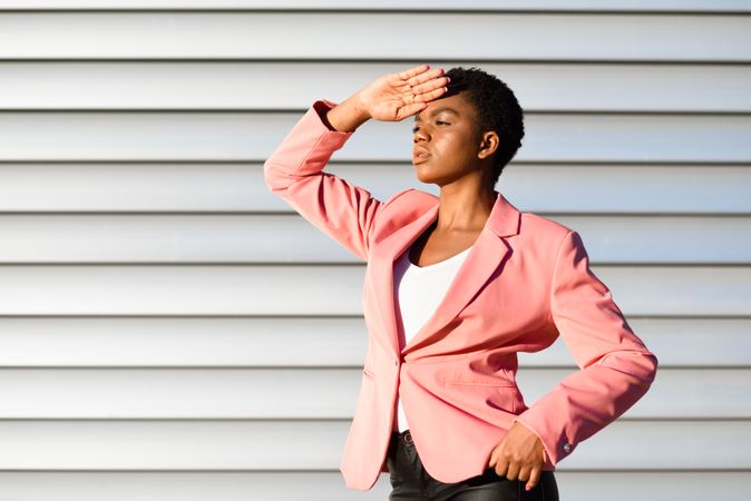 Side view of female making salut sign