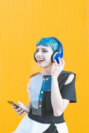 Futuristic woman using smartphone and listening to music