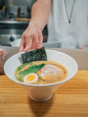Asian chef with served bowls of ramen