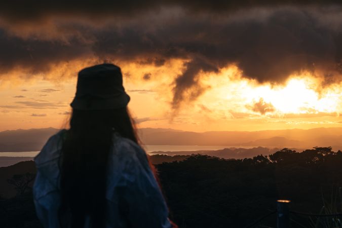 Woman watching the sunset in nature