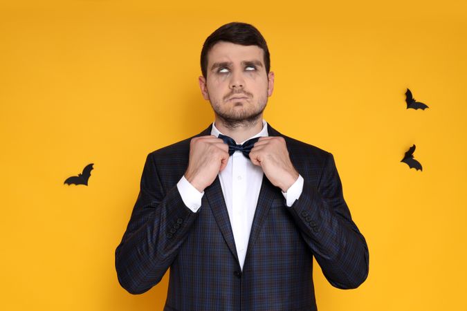 Concept of Halloween, young man on yellow background