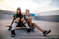 Woman skateboarders laughing and having fun 5qnRw4