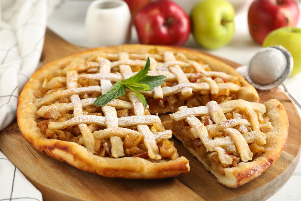 Tasty apple pie on wooden background, close up. Homemade food
