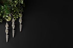 Festive icicles and leaves on dark background