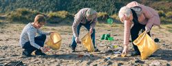Older volunteers cleaning the beach
