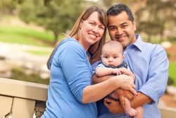 Happy Family Posing for A Portrait in the Park