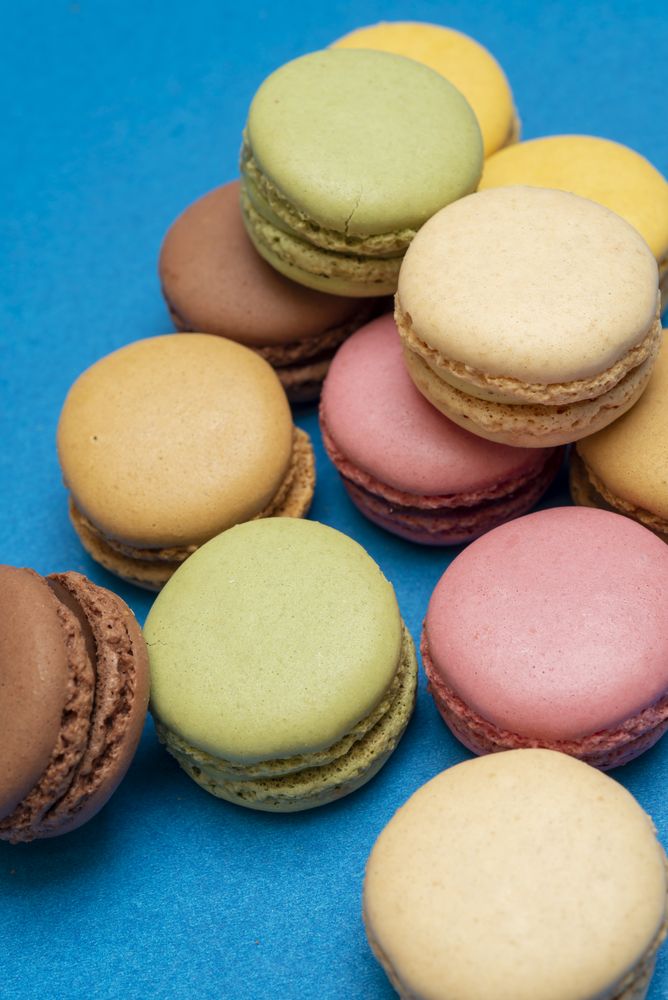 Pile of French pastel macaroons on a blue table