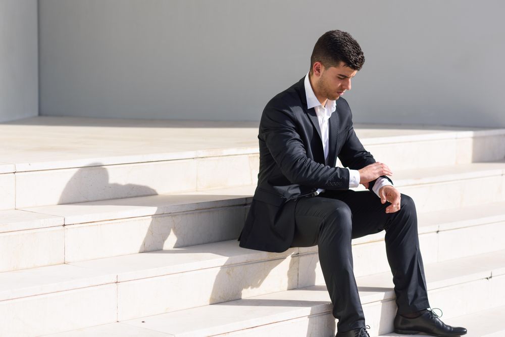 Man in suit sitting on stairs