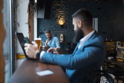 Two men looking st each other across the bar