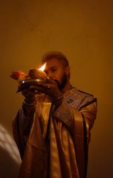 Man in robe holding candles celebrating Diwali