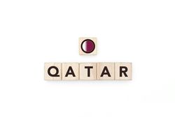 Wooden blocks bearing the name and flag of Qatar.