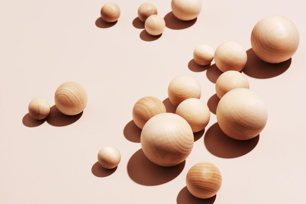 Wooden balls on neutral background