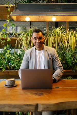 Man working on laptop at cafeteria