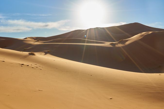 Sand dunes and blue sky with sun