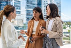 The female boss is informing her two employees that they need to focus on work rather than engaging in gossip.  One of them does not like her comment.