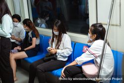 Group of passengers sitting in a subway train 47B9B5