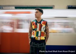 Male standing in London Underground with trail in motion behind 5wNay0